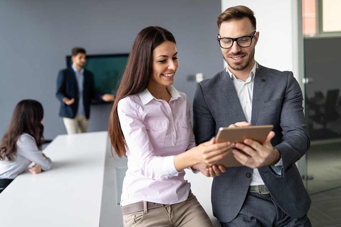 Business professionals collaborating and discussing financial solutions in a modern workplace