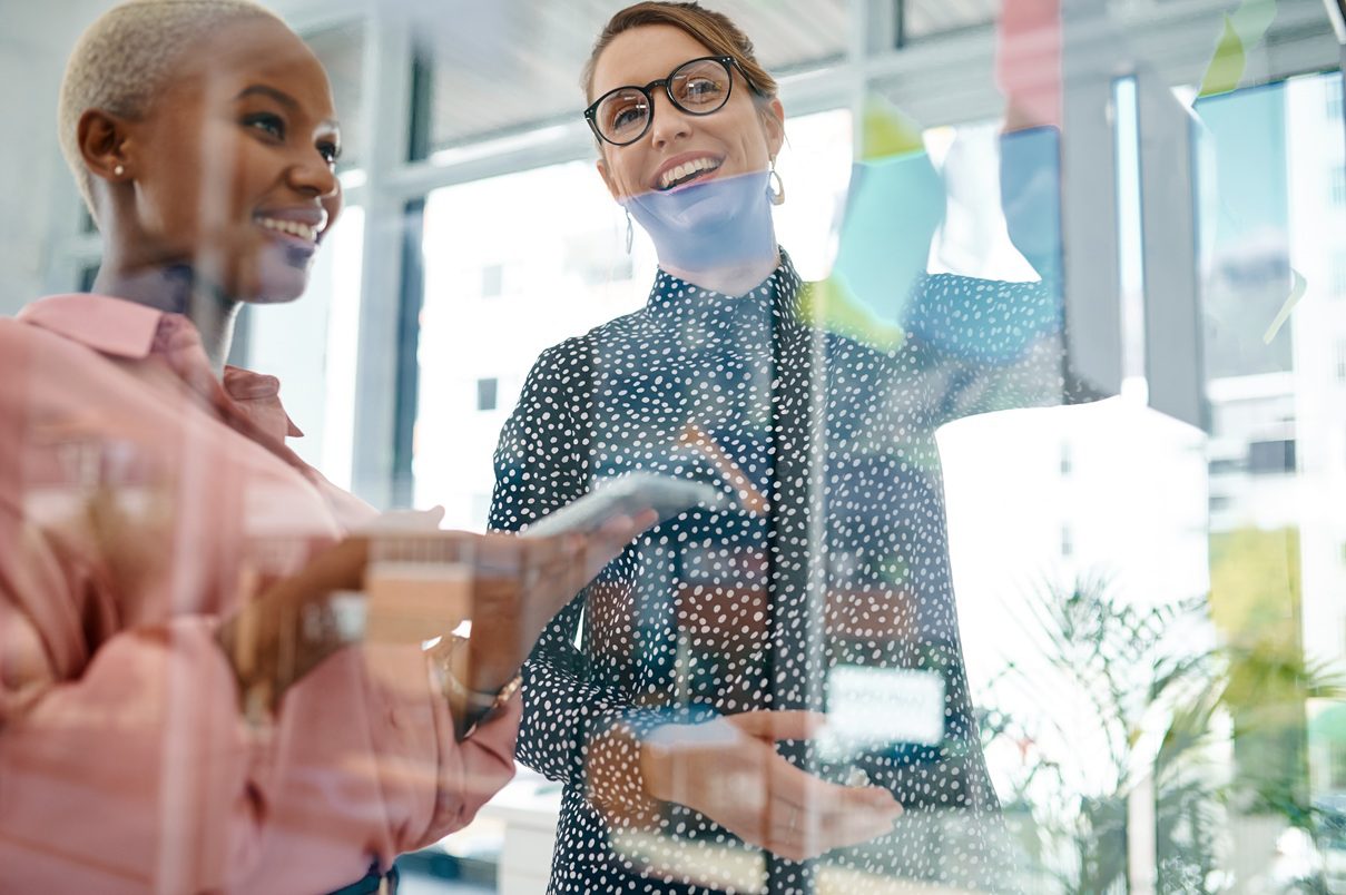 shot-of-two-businesswomen-brainstorming-with-notes