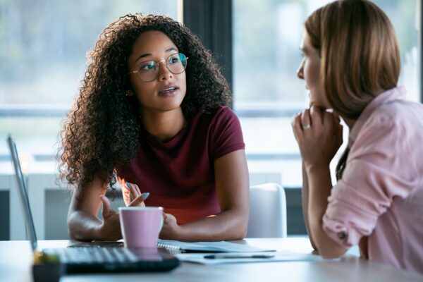 Two business professionals collaborating and working together in a modern workplace