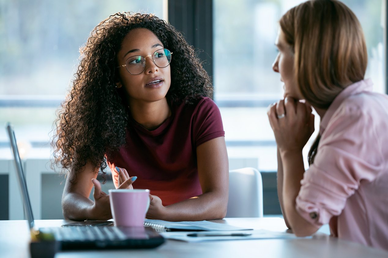 Two business professionals collaborating and working together in a modern workplace